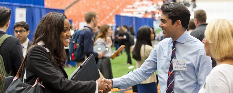 Student shaking hands with an employer at the career fair.