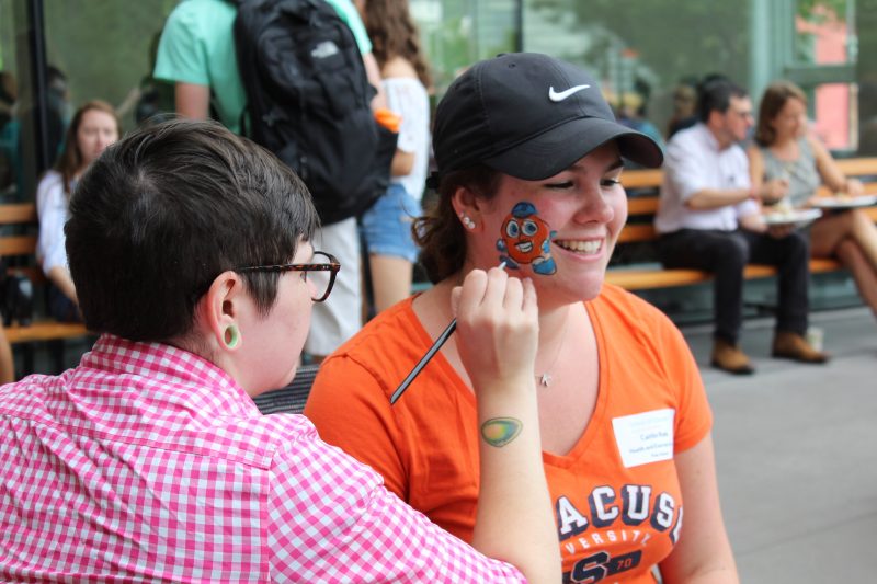 A student gets Otto painted on her face during a welcome back picnic