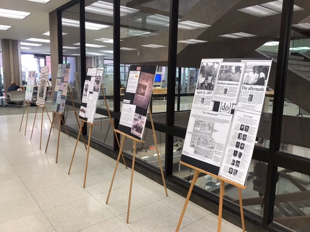 posters on easels along glass wall