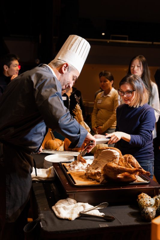 Chef carving turkey for international students.