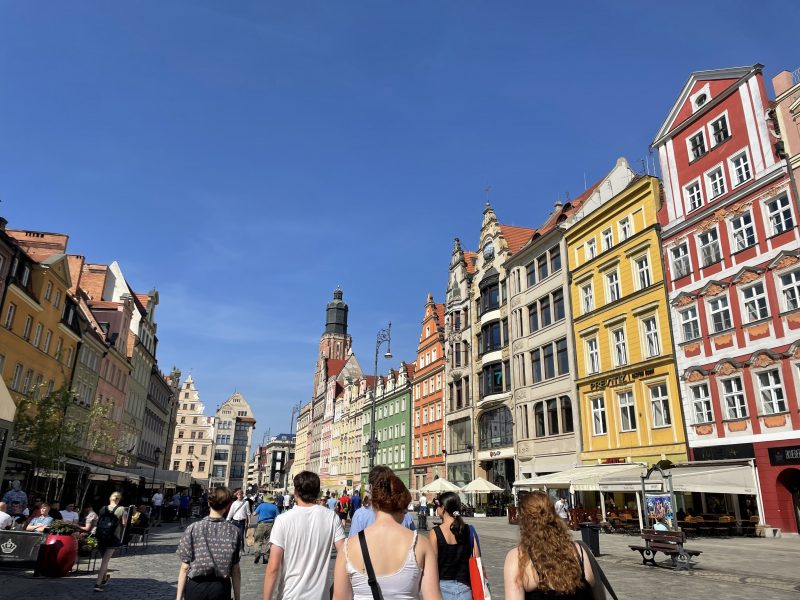 Photo of a European city with people walking through it.