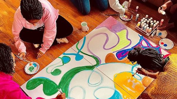 Young students making art on the floor