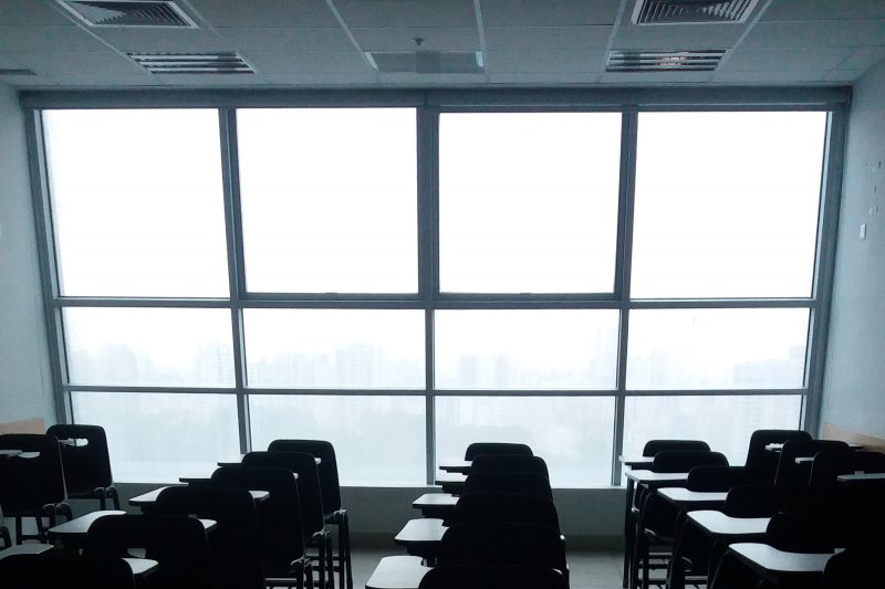 Photo of an empty classroom showing windows and HVAC in the ceiling