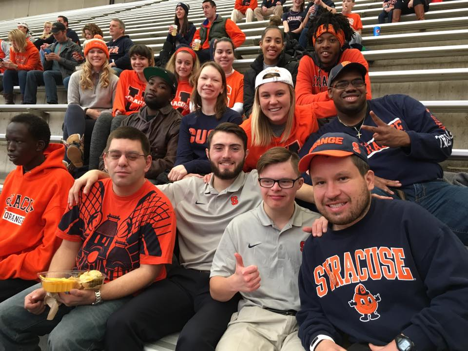 Cleo Hamilton, Tori Cedar, and a group of InclusiveU students and staff attend a Syracuse basketball game