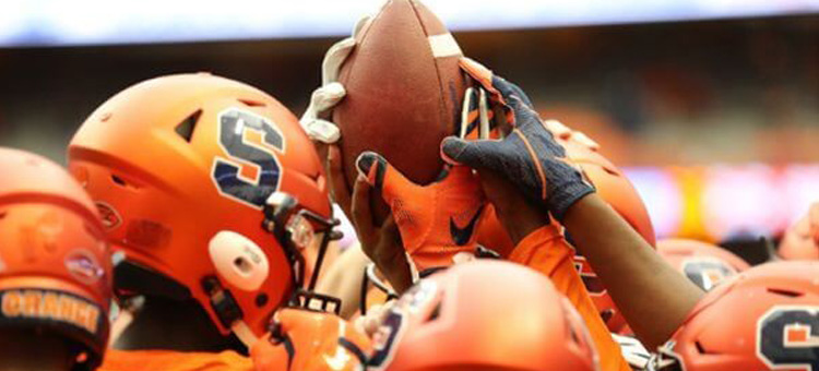 Syracuse University Helmets with Football Raised in the air