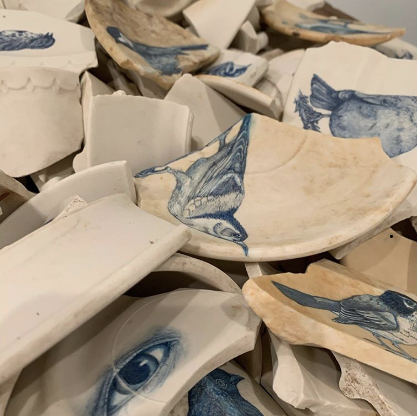 ceramic shards with blue sketches of birds