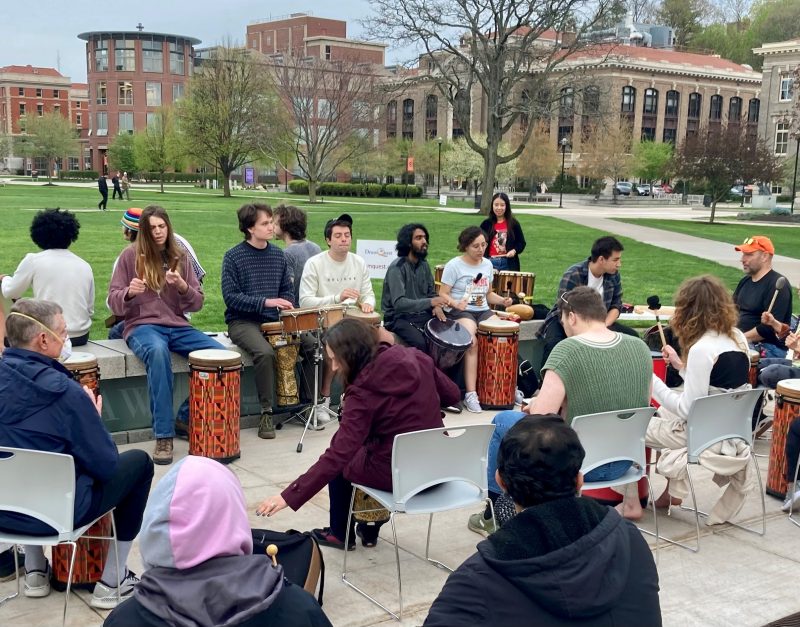 People playing a variety of drums on the Quad