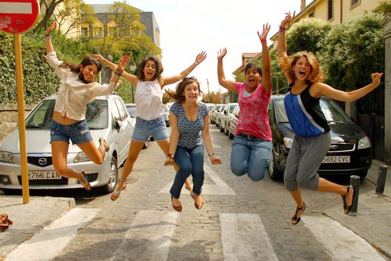 Students jumping on a crossing walk,  El Escorial, Spain.