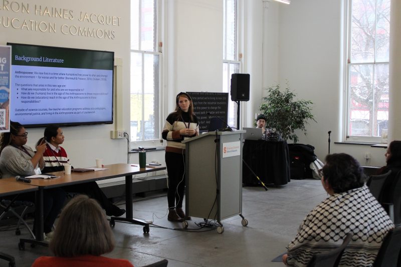 A graduate student delivering a paper at a podium