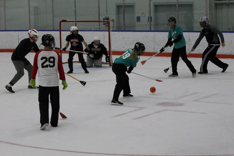 Players compete in a game of broomball.