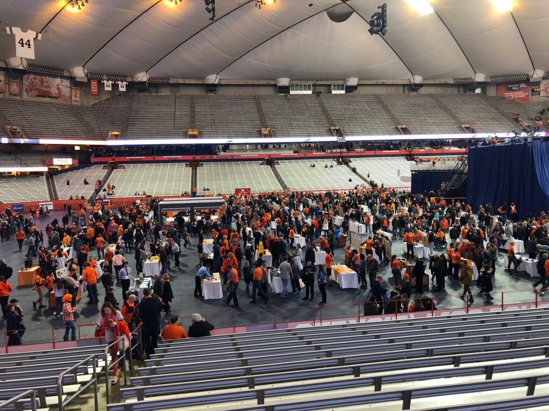 People bidding on items at annual Charity auction at Carrier Dome