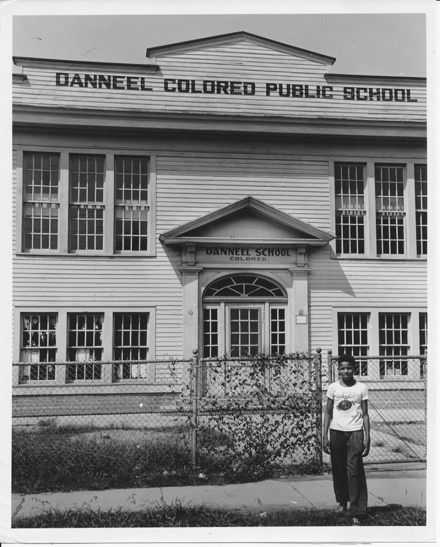 Photo of a Young boy in front of a school