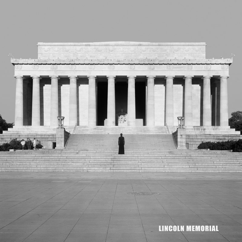 Woman stands in front of the Lincoln Memorial 