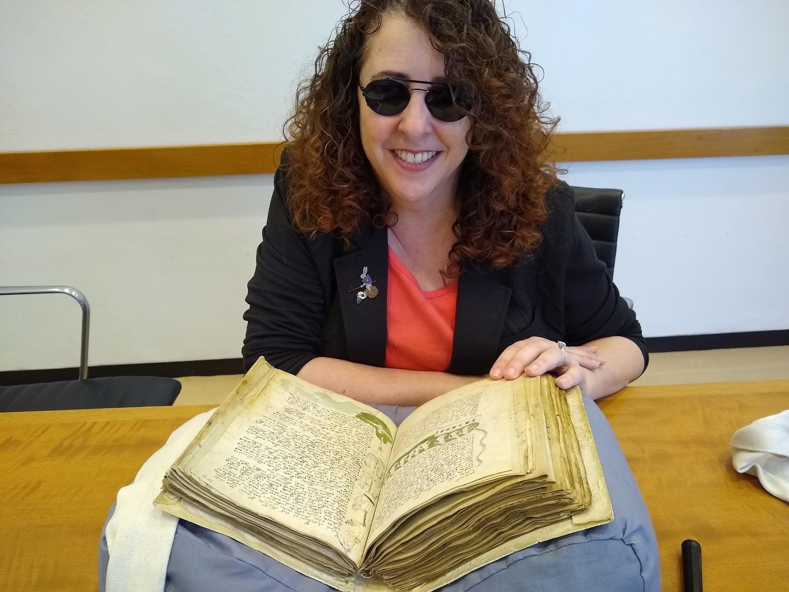 person sitting in front of medieval book