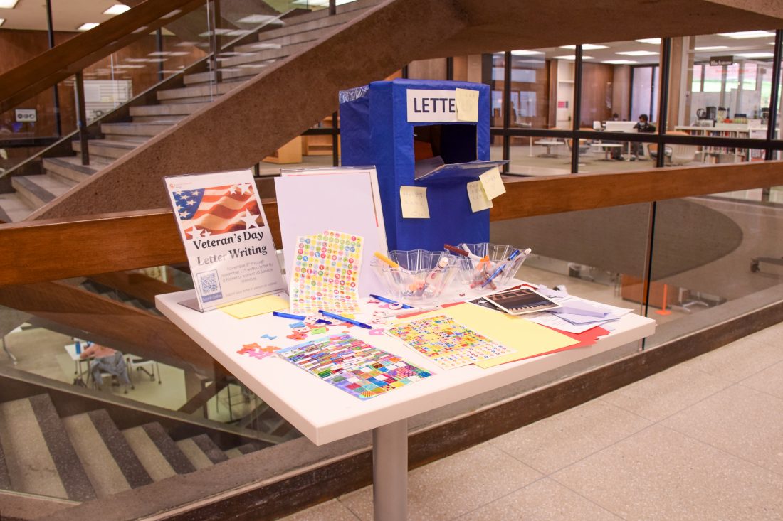 table with letter writing supplies, cardboard mailbox and directions