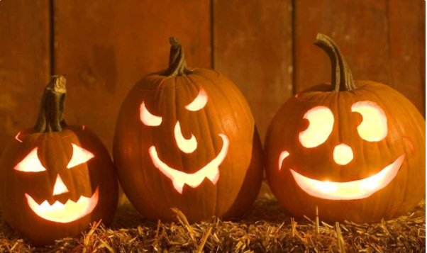 Three jack-o-lanterns. One with a happy face, one with a devious face and one with a goofy smile. 