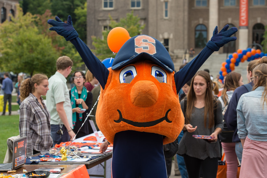 view of Syracuse University Quad during involvement fair, with students at tables talking