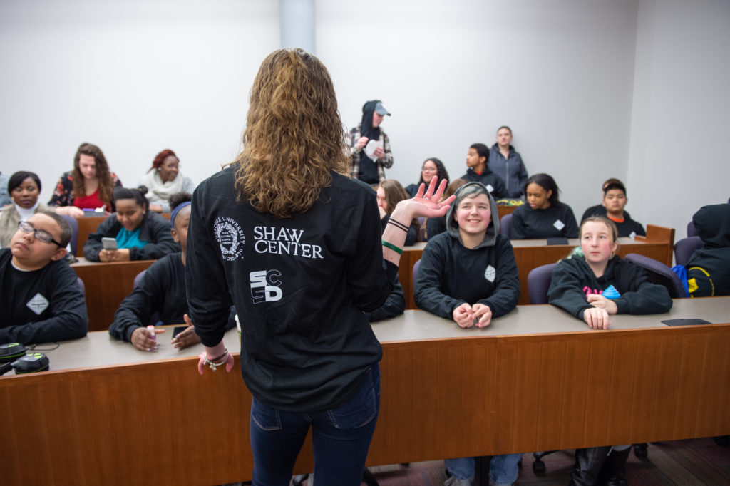 Shaw Center student intern speaks to a classroom of youth.