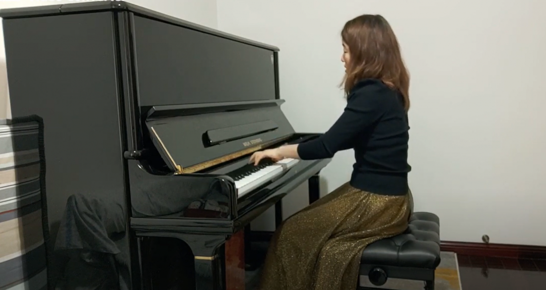 A student plays the piano.