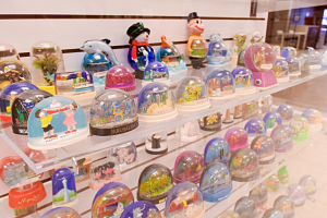 shelves of various plastic colorful snow domes