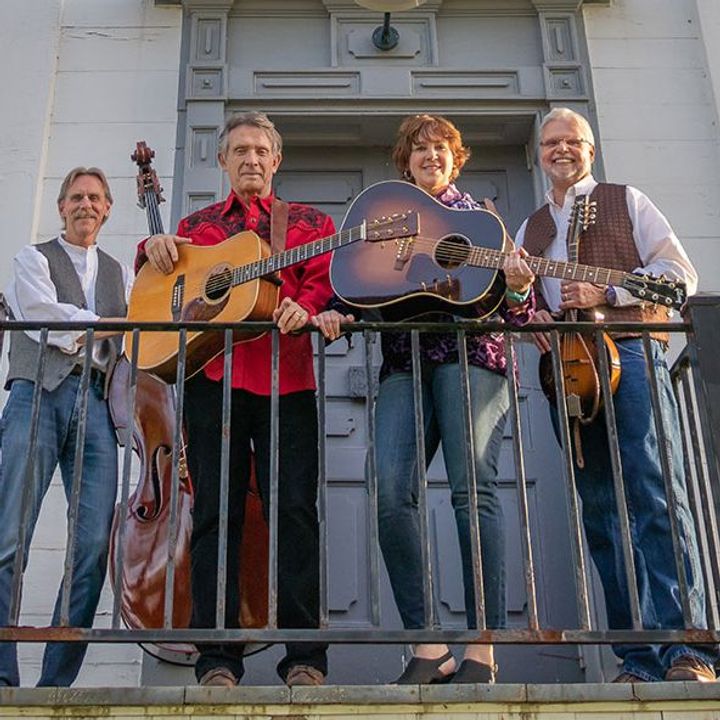 Members of The Cadleys band pose together holding guitars