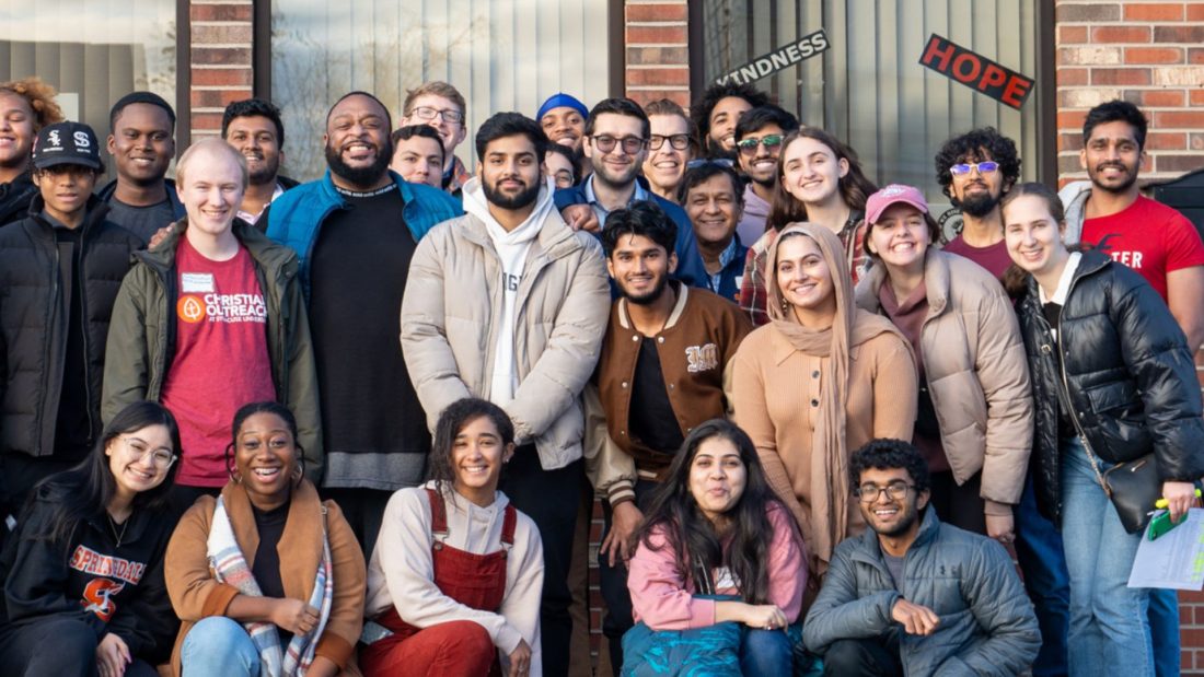 Students and others gathered in front of a building.