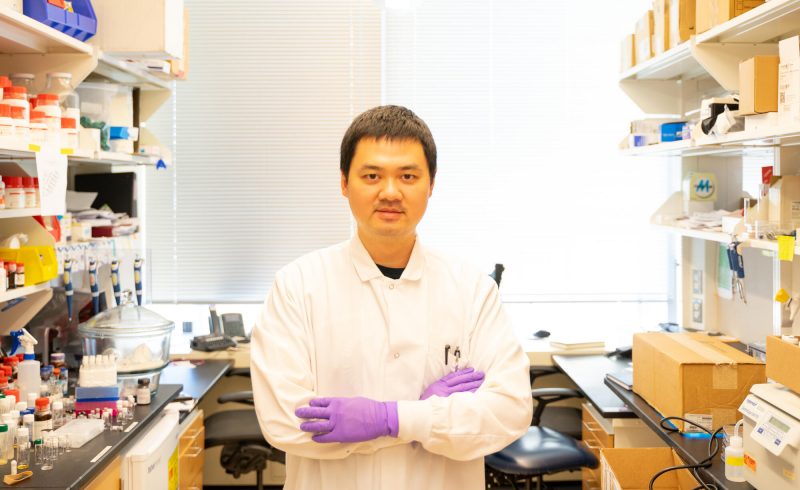 Dr. Jiawei Yang standing in a research lab