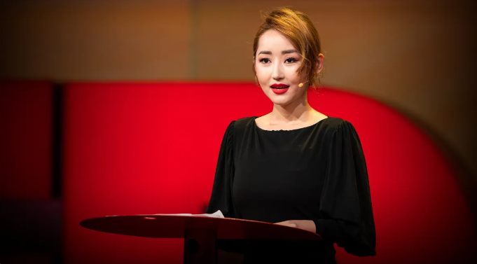 Yeonmi Park speaking at a podium