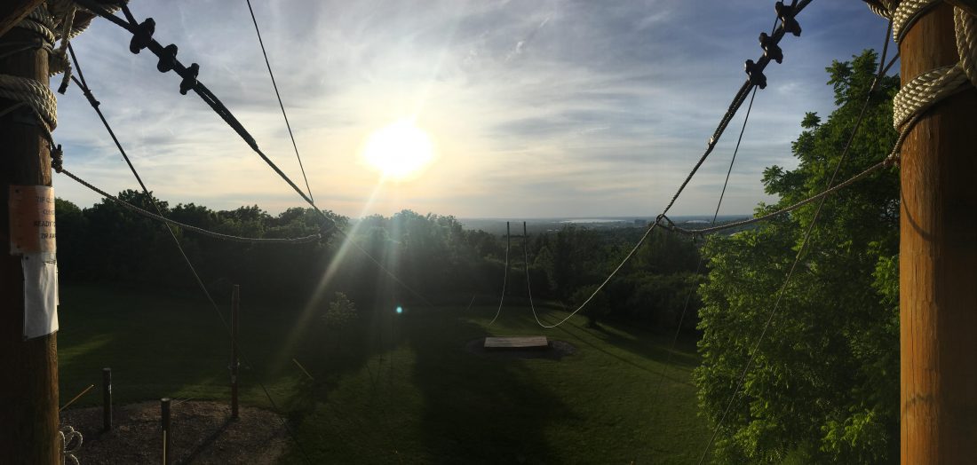 A view of the Syracuse skyline at dusk from the south campus challenge course.