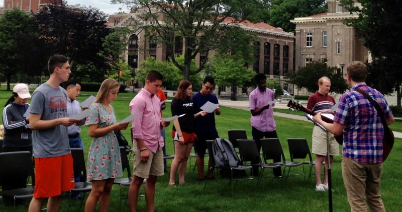 Students standing outside and fellowshipping.