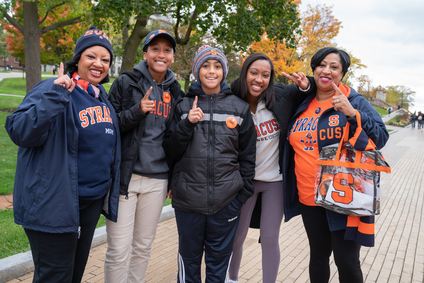 student savannah stocker poses with her mother, grandmother, and siblings all wearing SU gear on the einhorn family walk