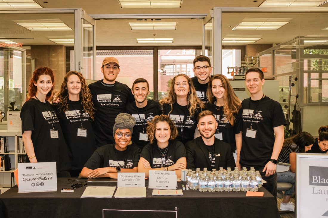 group of student wearing black t-shirts and posed in front of LaunchPad in library