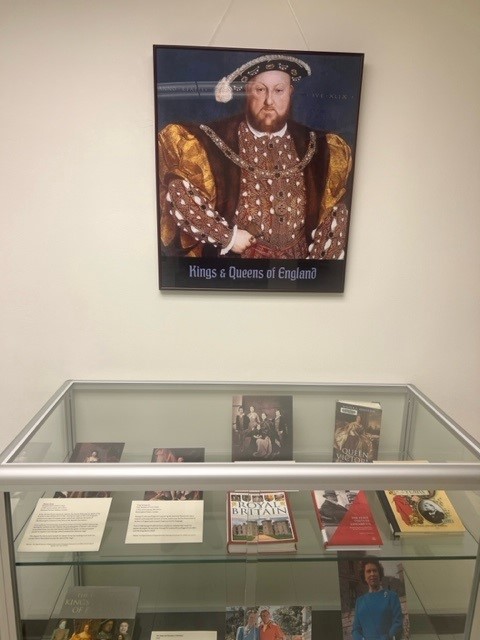 poster of king of England above glass display case