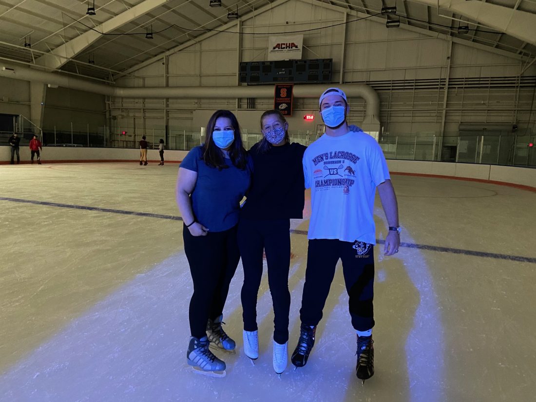 Three students ice skating at Late Night Ice.