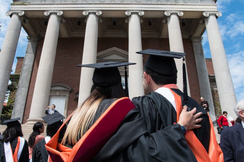 Graduating students embracing.