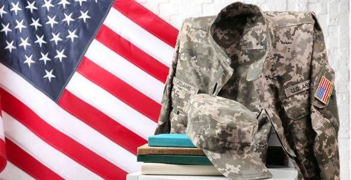 Visual of a stack of books and military uniform in front of an American flag backdrop