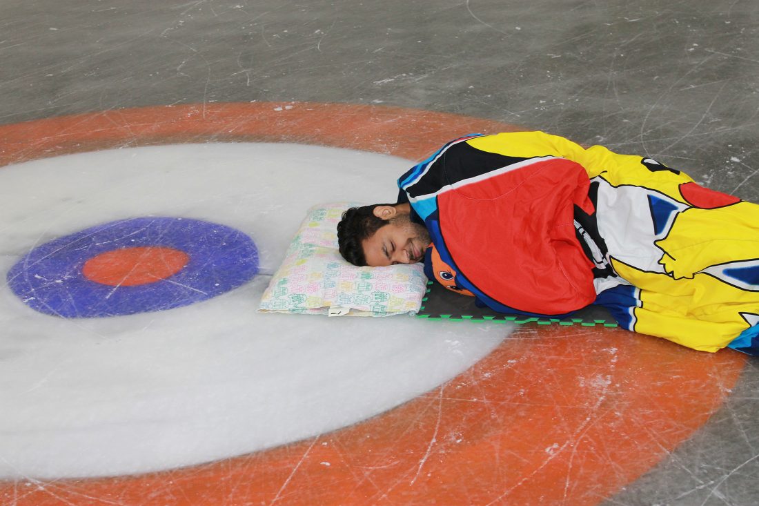 A student naps on the ice awaiting the Pajama Jam.