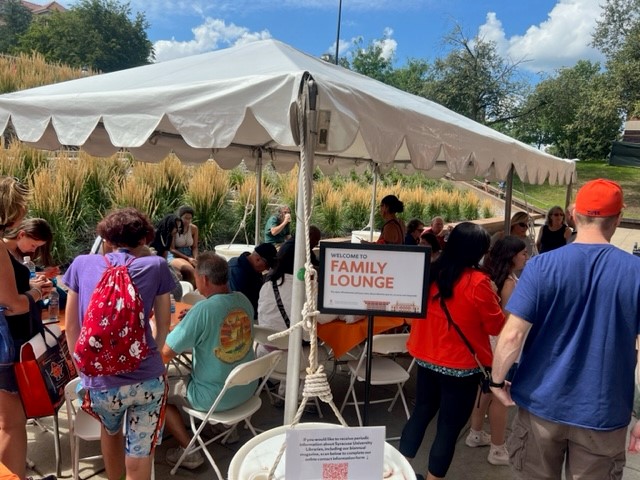 people standing under tent