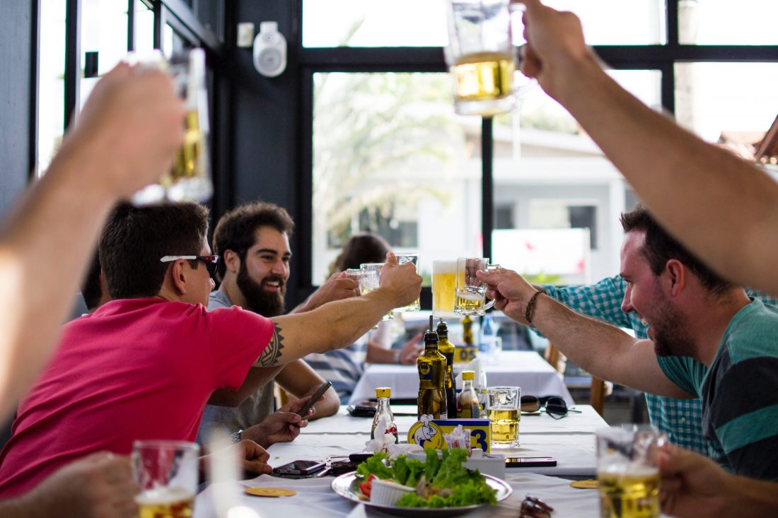 People cheering with drinks in restaurant