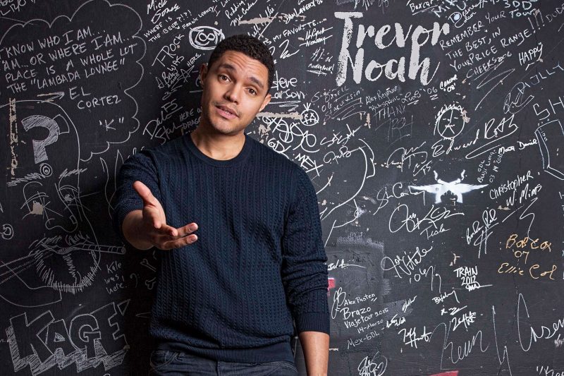 Trevor Noah in front of chalkboard