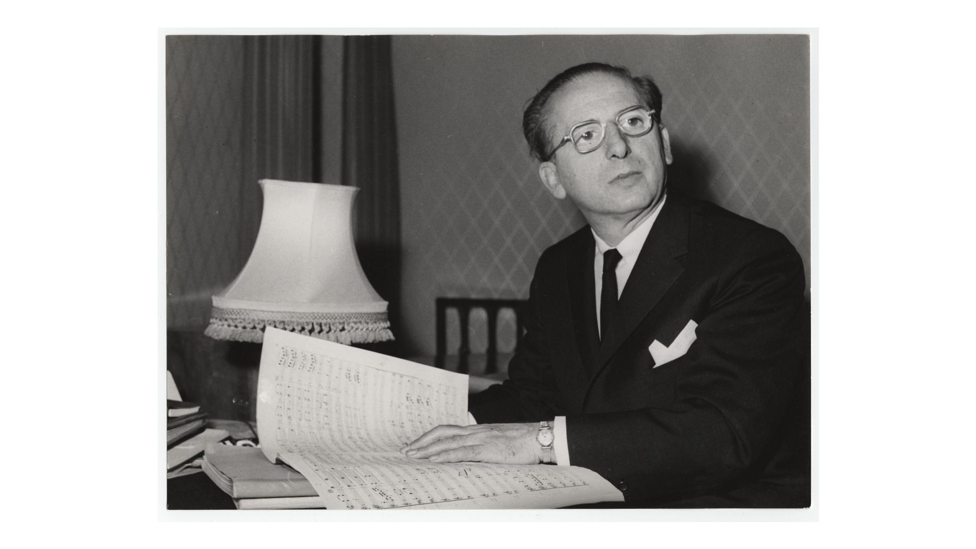 man at table with musical score