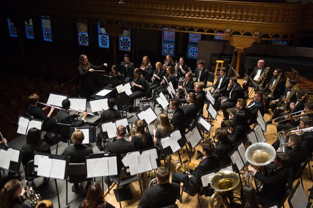 The wind ensemble performs.